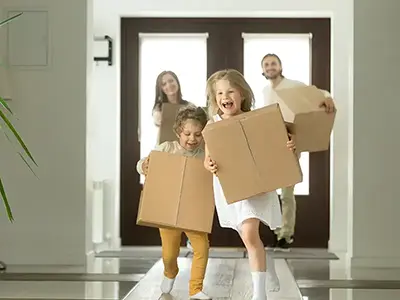 family with boxes in new home