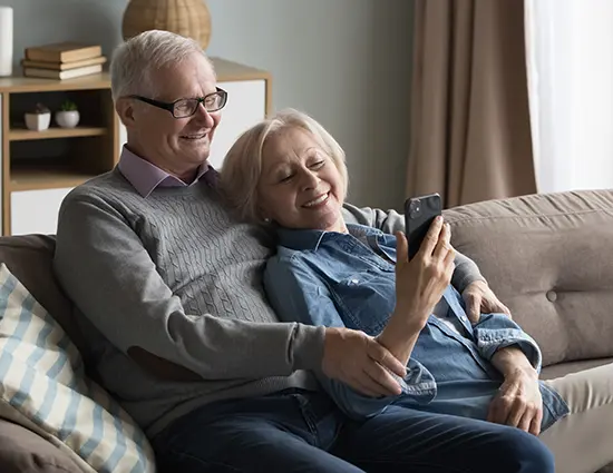 Couple on couch with mobile phone